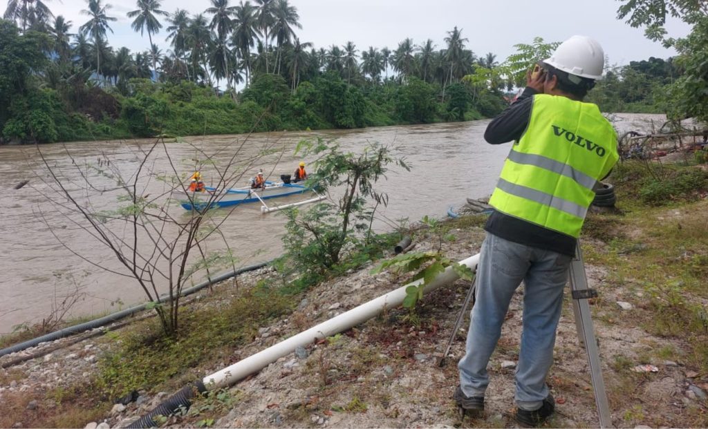 Geophysical team conducting subsurface investigation using resistivity equipment in the field.